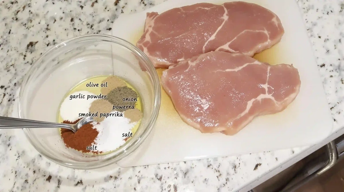 Ingredients for thin pork chops in air fryer including pork chops, olive oil, garlic powder, onion powder, smoked paprika, salt, and pepper Ingredients for thin pork chops in air fryer including pork chops, olive oil, garlic powder, onion powder, smoked paprika, salt, and pepper